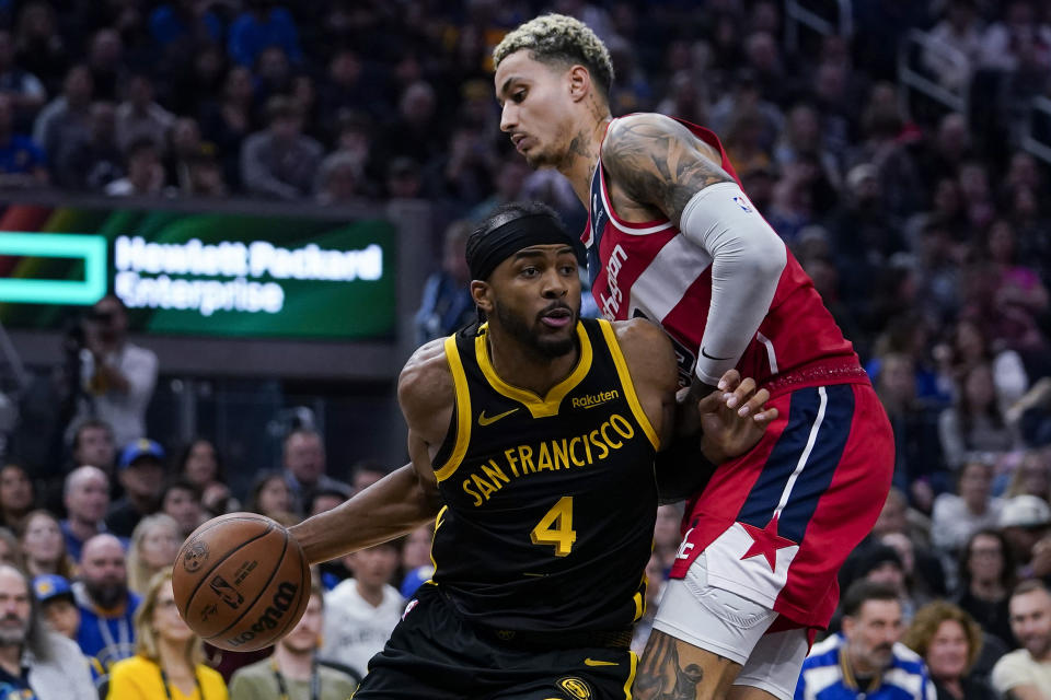 Golden State Warriors guard Moses Moody, left, tries to get around Washington Wizards forward Kyle Kuzma during the first half of an NBA basketball game Friday, Dec. 22, 2023, in San Francisco. (AP Photo/Godofredo A. Vásquez)