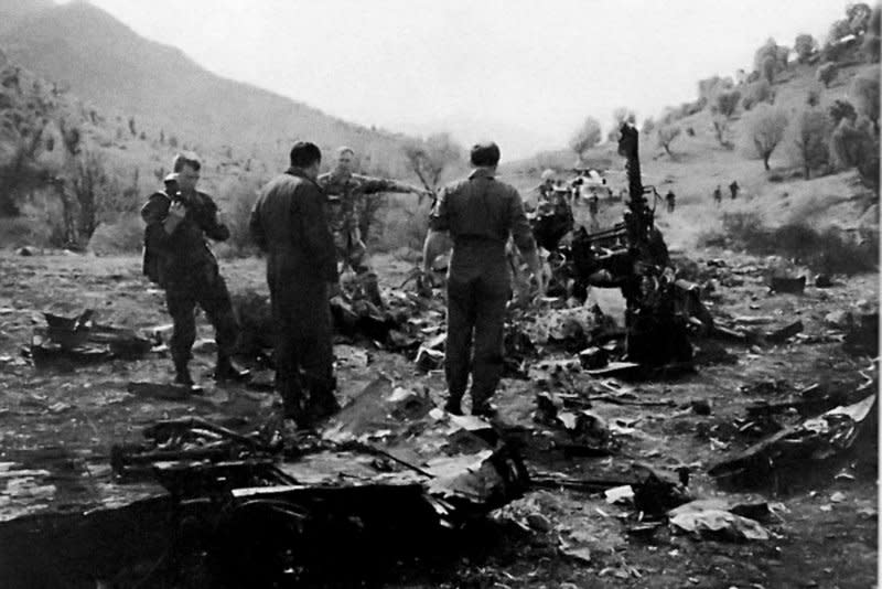 U.S. military personnel inspect the wreckage of a Black Hawk helicopter in the northern Iraq No Fly Zone during Operation Provide Comfort on April 15 or 16, 1994. The helicopter was one of two U.S. Army Black Hawks shot down by U.S. Air Force F-15 fighters on April 14, 1994 in a friendly fire incident. File Photo courtesy of the U.S. Air Force