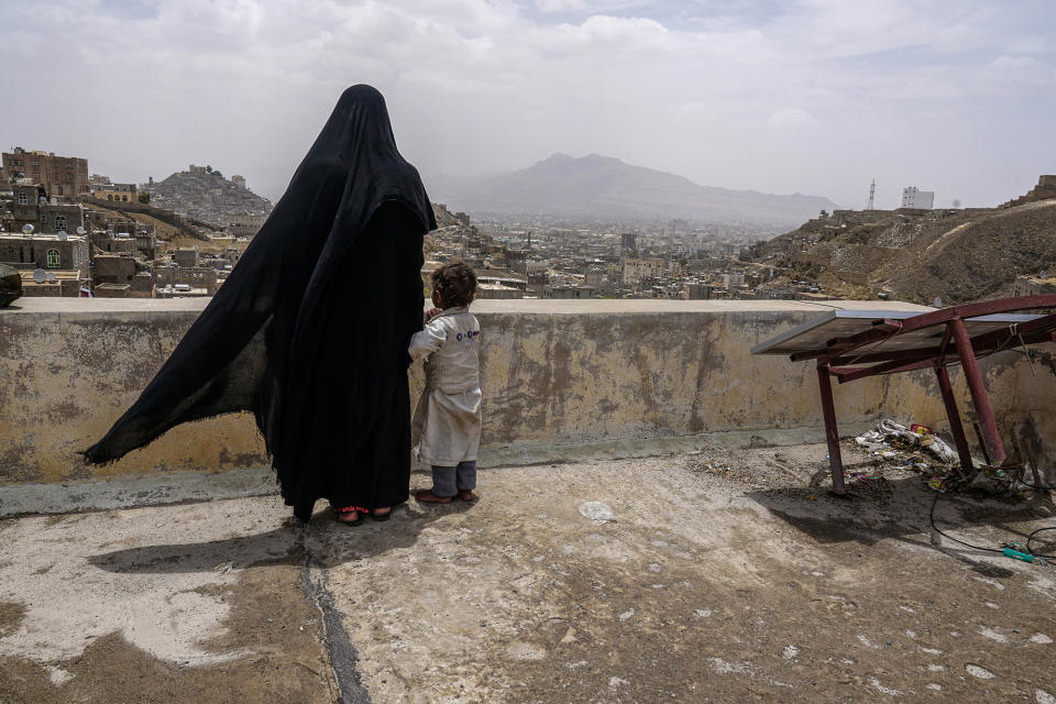 <p>IDP building, Sana’a outskirts, Yemen, May 1, 2017: Khairy, a mother of three, stands on the roof of her temporary home in Sana’a. (Photograph by Giles Clarke for UN OCHA/Getty Images) </p>