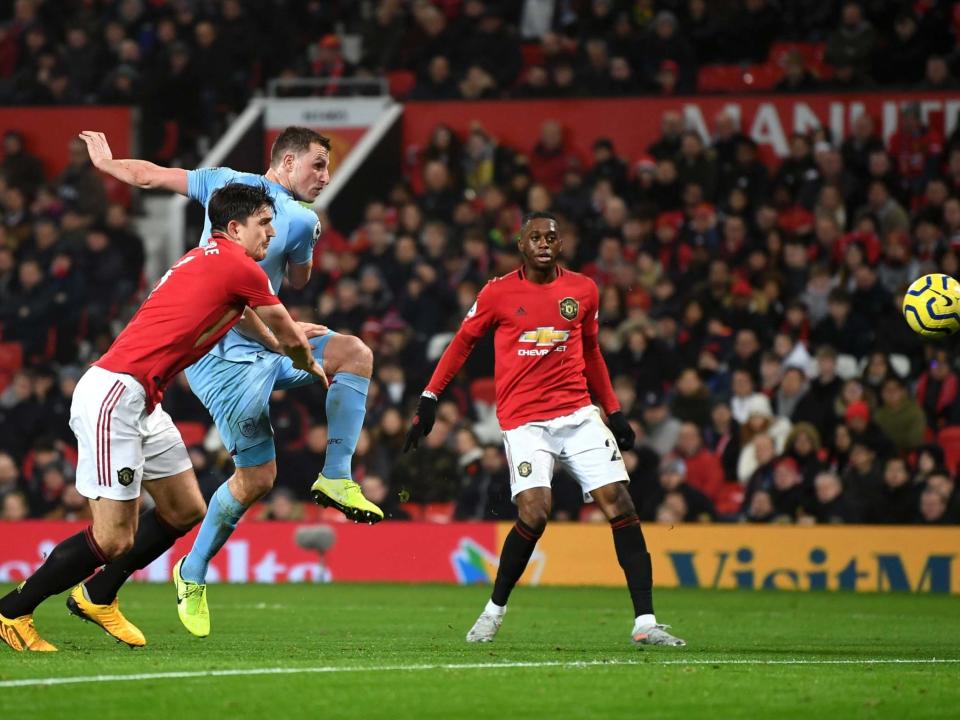 Harry Maguire cannot stop Chris Wood from firing home the first goal: Getty Images