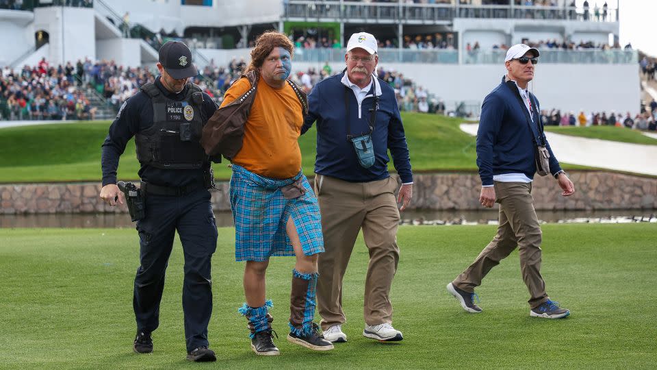 Police and staff apprehend a fan dressed as William Wallace from "Braveheart" after he ran onto the 11th hole during the second round. - Christian Petersen/Getty Images