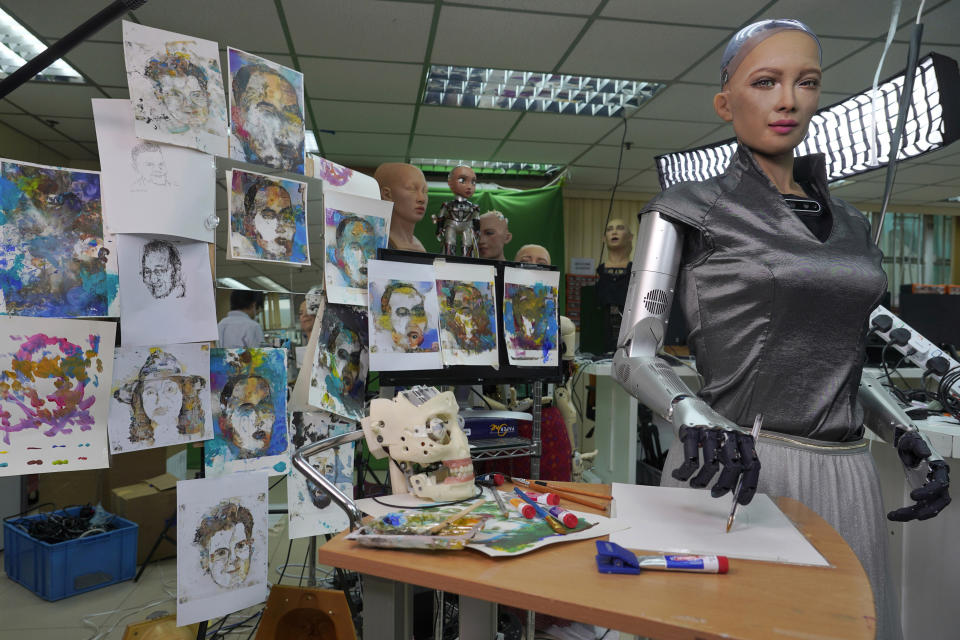 Sophia's artworks are displayed at Hanson Robotics studio in Hong Kong on March 29, 2021. Sophia is a robot of many talents — she speaks, jokes, sings and even makes art. In March, she caused a stir in the art world when a digital work she created as part of a collaboration was sold at an auction for $688,888 in the form of a non-fungible token (NFT). (AP Photo/Vincent Yu)