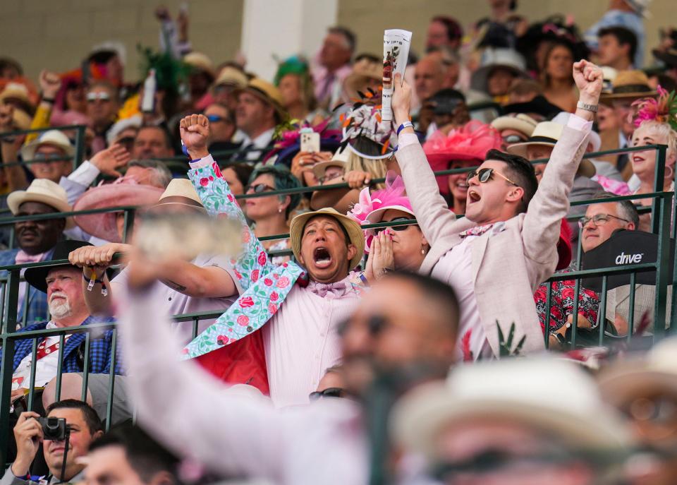 Bettors celebrate a win while watching an undercard race from the First Turn Club at the Kentucky Derby Saturday at Churchill Downs in Louisville, Ky. May, 6, 2023.
