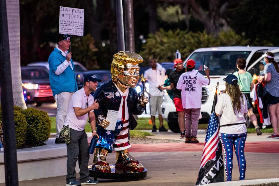 <p>Golden statue of former US president Donald Trump at CPAC</p> (AFP via Getty)