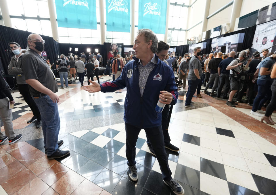 Colorado Avalanche general manager Joe Sakic, center, talks with reporters during media day before Game 1 of the Stanley Cup Finals against the Tampa Bay Lightning, Tuesday, June 14, 2022, in Denver. (AP Photo/David Zalubowski)