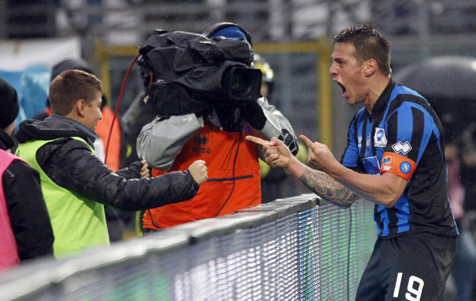 Atalanta's German Denis, right, of Argentina, celebrates his second goal with his son Matias during a Serie A soccer match against Napoli in Bergamo, Italy, Sunday, Feb. 2, 2014. (AP Photo/Felice Calabro')