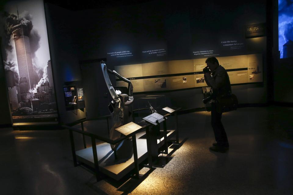 A member of the media take a photo in the historical exhibition section of the National September 11 Memorial & Museum during a press preview in New York May 14, 2014. A museum commemorating the Sept. 11, 2001 attacks on New York and Washington is on the verge of opening, with wrenchingly familiar sights as well as artifacts never before on public display. Among the first visitors to the National September 11 Memorial Museum are victims' family members and others intimately involved in its creation who will attend on Thursday, after a Wednesday media preview. The doors open to the general public on May 21. (REUTERS/Shannon Stapleton)