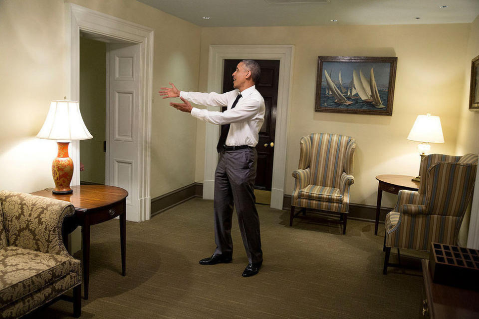 Obama gestures to a departing guest in a hallway of the West Wing of the White House on April 29, 2015.