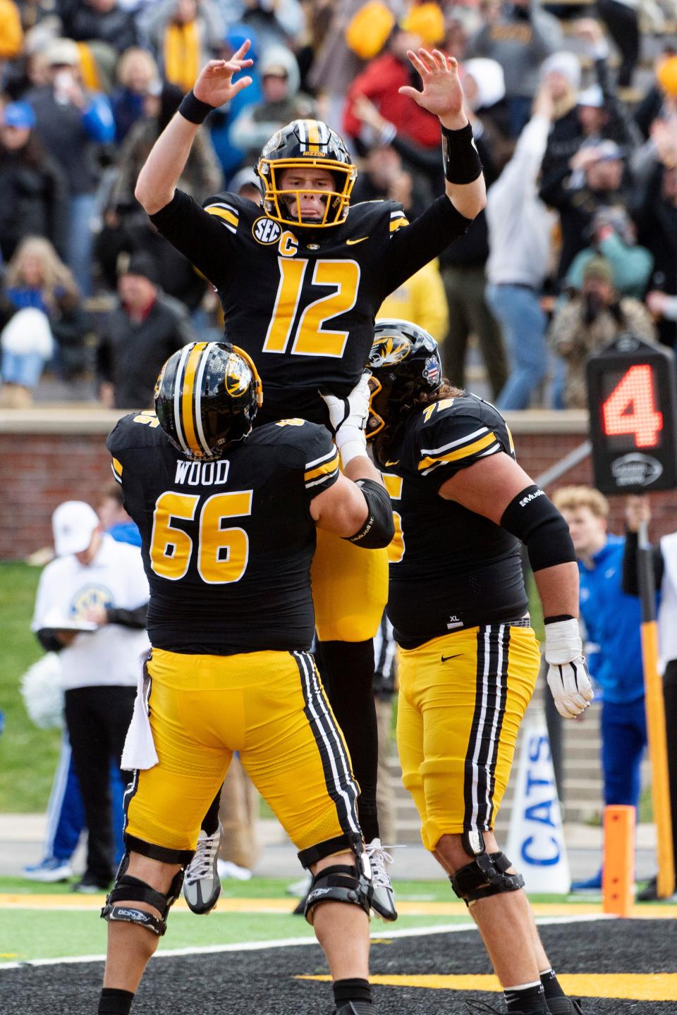 Missouri quarterback Brady Cook, top, is lifted in the air by offensive lineman Connor Wood after scoring a touchdown during the fourth quarter of an NCAA college football game against Kentucky, Saturday, Nov. 5, 2022, in Columbia, Mo. (AP Photo/L.G. Patterson)