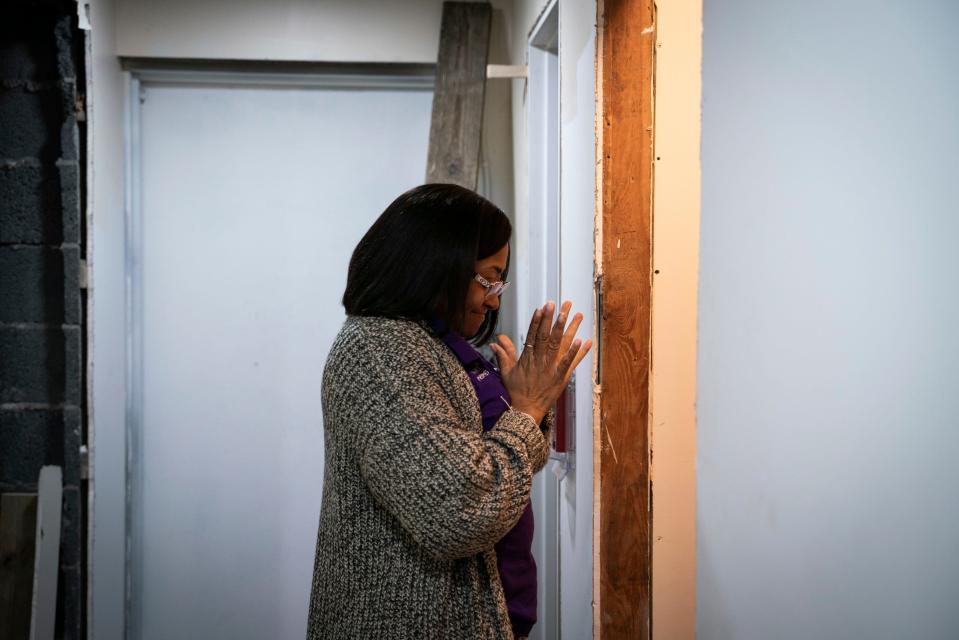 Betty Henderson, 51, reacts with joy after seeing that toilets have been installed inside the bathrooms at her new building undergoing construction in Detroit on Jan. 19, 2023. During the summer, the building that Henderson was hoping to renovate in order to expand her current child care facility, caught on fire and was destroyed. Now, Henderson restarts the renovation process.