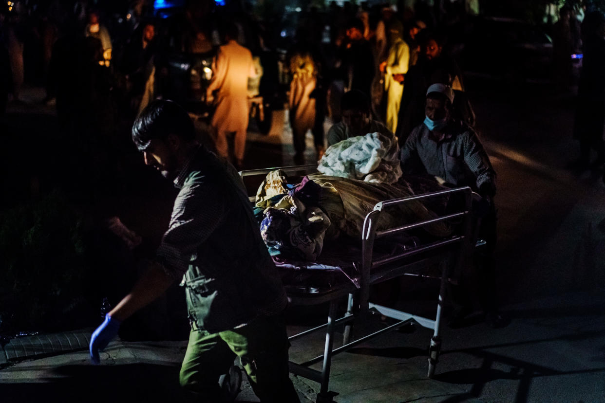 Hospital  staff rolls in a casualty that was brought by Taliban fighters at Emergency Hospital in Kabul, Afghanistan, Thursday, Aug. 26, 2021. (Marcus Yam/Los Angles Times via Getty Images) 