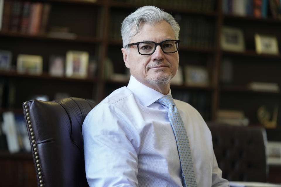 FILE - Judge Juan M. Merchan poses in his chambers in New York, March 14, 2024. Manhattan prosecutors are urging the judge overseeing Donald Trump’s criminal hush money case to uphold a gag order that bars the Republican former president from criticizing jurors, court staff, or members of the prosecution that convicted him. In court papers filed Friday, prosecutors with the Manhattan district attorney’s office argued portions of the gag order remained necessary given Trump’s “singular history of inflammatory and threatening public statements." (AP Photo/Seth Wenig, File)