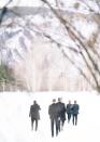 Some adventurous young men walking into the snowy field where our ceremony was to be held.