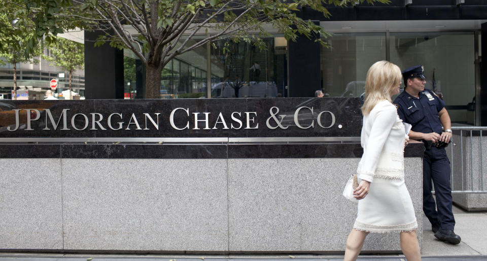 A woman walks past JPMorgan Chase & Co's international headquarters on Park Avenue in New York July 13, 2012. Jamie Dimon will do his best to put the 