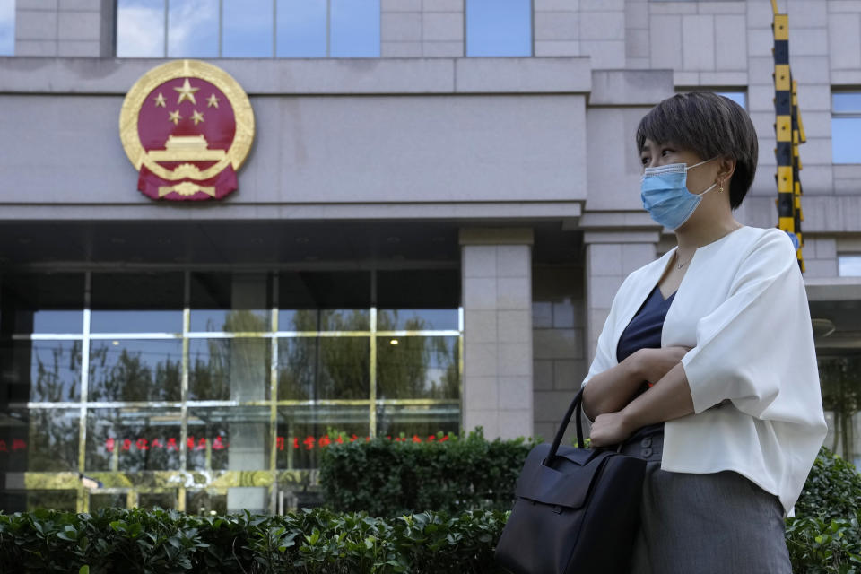 Teresa Xu prepares to attend a court session at the Chaoyang People's Court in Beijing, China, Friday, Sept. 17, 2021. After almost two years, the unmarried woman suing for the right to freeze her eggs in Beijing is getting her case heard in court Friday in a rare legal challenge against the country's restrictions on unmarried women in reproductive health. (AP Photo/Ng Han Guan)