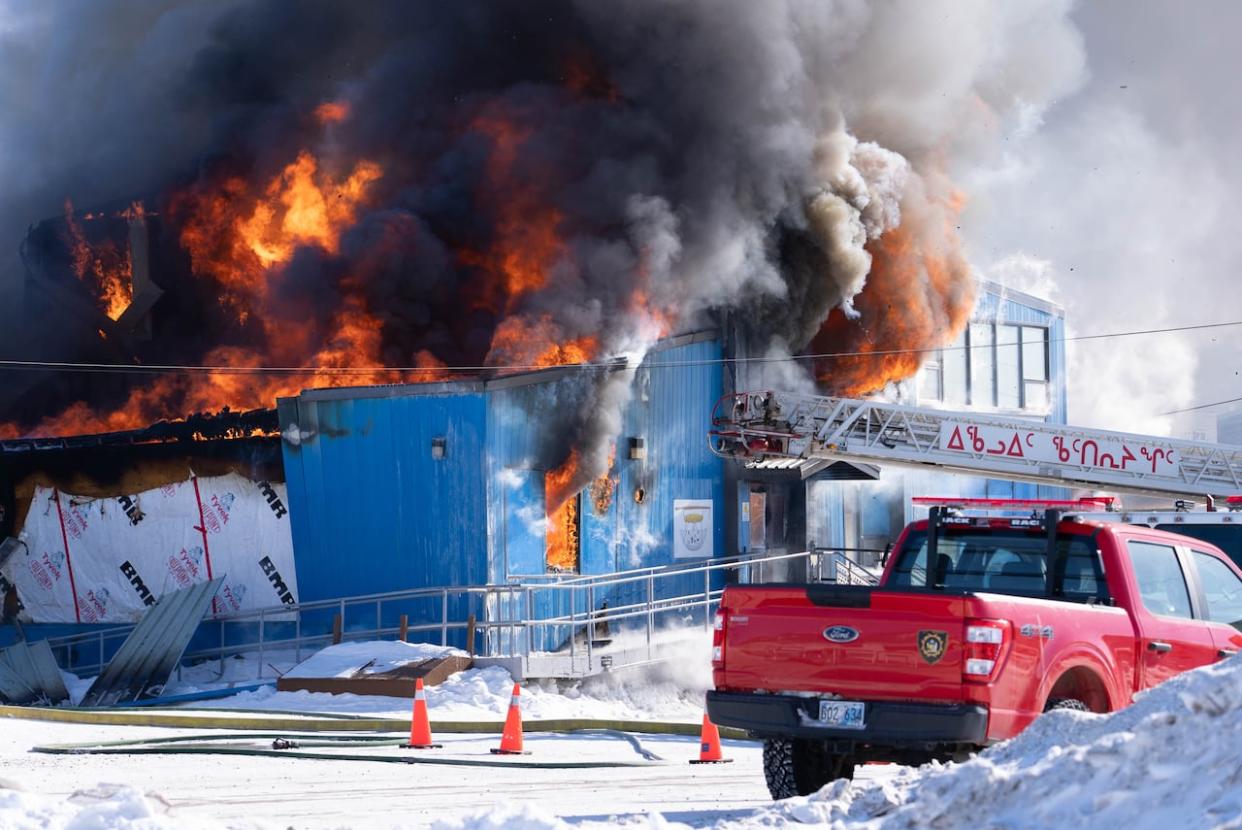 Flames and smoke engulf Building 157 in Iqaluit, where a fire has been burning for hours Tuesday morning.  (Dave Gunn/CBC  - image credit)