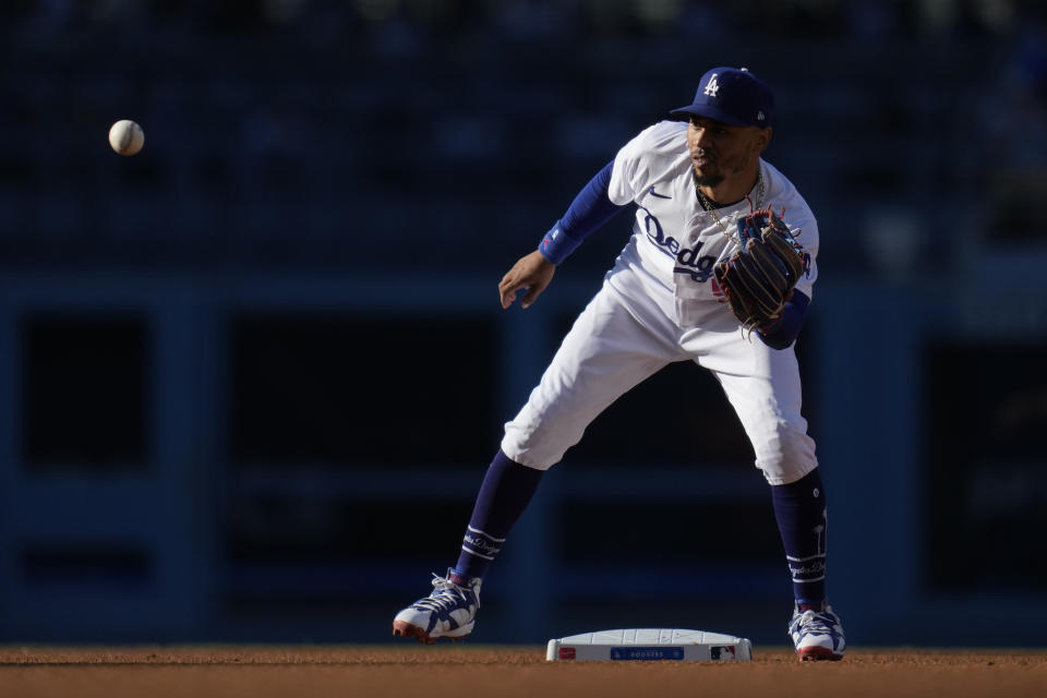 Los Angeles Dodgers second baseman Mookie Betts (50) warms up between the second and third innings of a baseball game against the San Francisco Giants in Los Angeles, Sunday, Sept. 24, 2023. (AP Photo/Ashley Landis)