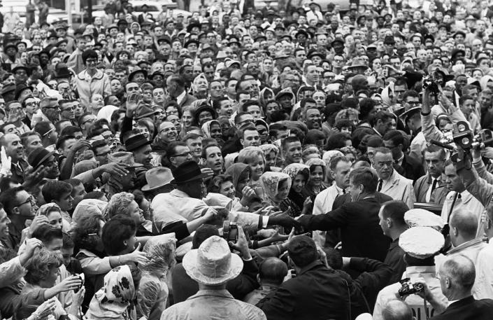 President Kennedy shakes hands with people in a crowd in Ft. Worth, Texas, on the day of his assassination, Nov. 22, 1963. (Photo: Corbis via Getty Images)