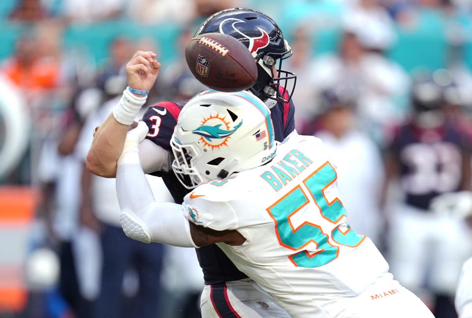 Miami Dolphins linebacker Jerome Baker (55) knocks the ball out of Houston Texans quarterback Kyle Allen’s (3) hands during the second half of an NFL game at Hard Rock Stadium in Miami Gardens, Nov. 27, 2022. 