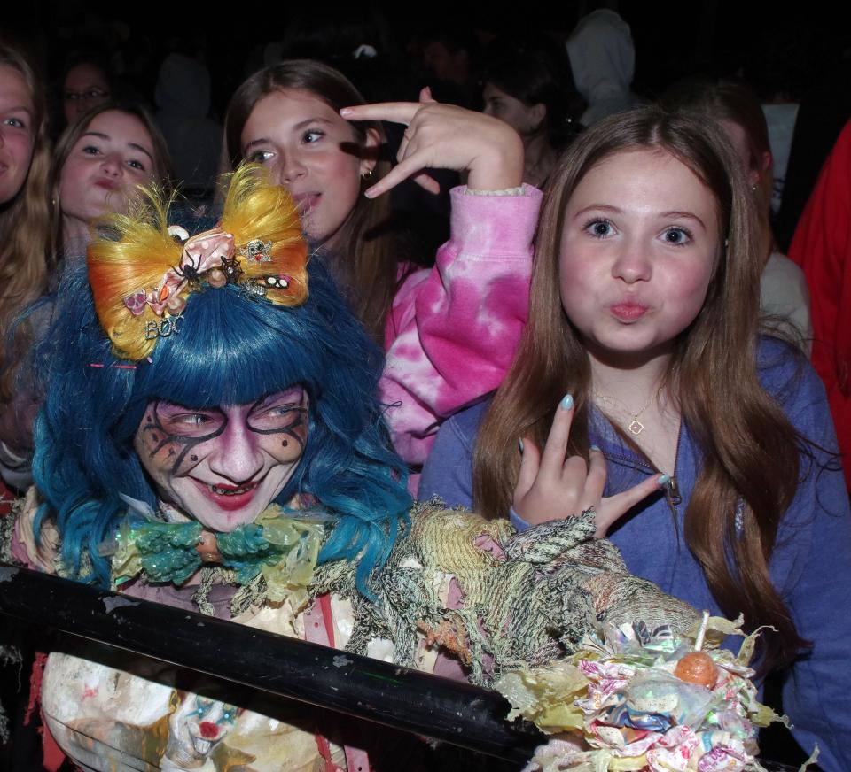 Caroline Kelley, 12,  Siofra Faherty, 13,  and Hannah Mattivello, 13, all from Milton, get to know the blue-haired character of "Oopsie," played by Lisa St. Martin of Avon, at Barrett's Haunted House in Abington on Sunday, Oct. 9, 2022.