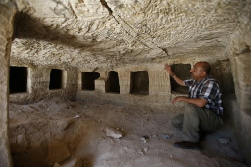 Taleb Jubran, director of the department of tourism and antiquities in Hebron, points to a Roman-era burial site discovered near the West Bank city of Hebron, on August 16, 2018