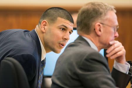 Former New England Patriots player Aaron Hernandez speaks with his attorney Charles Rankin during his murder trial at the Bristol County Superior Court in Fall River, Massachusetts, March 9, 2015. REUTERS/Aram Boghosian/Pool