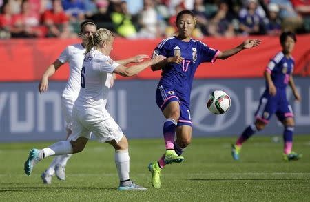 Jul 1, 2015; Edmonton, Alberta, CAN; England defender Laura Bassett (6) and Japan forward Yuki Ogimi (17) fight for the ball during the second half in the semifinals of the FIFA 2015 Women's World Cup at Commonwealth Stadium. Mandatory Credit: Erich Schlegel-USA TODAY Sports