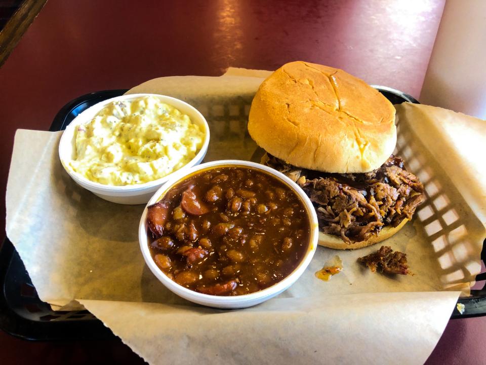 The pulled pork sandwich with beans and potato salad at Hickory Hut in Salina.