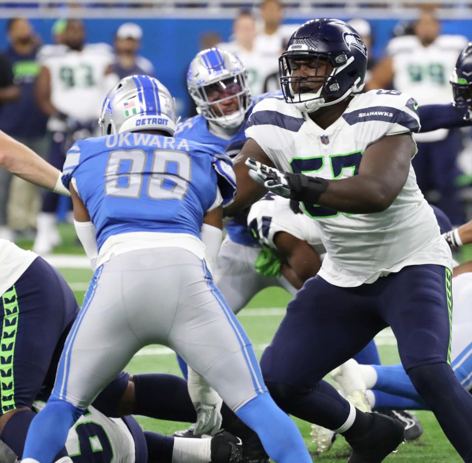 Oct 2, 2022; Detroit, Michigan, USA; Seattle Seahawks offensive tackle Charles Cross (67) blocks Detroit Lions linebacker Julian Okwara (99) during first half action at Ford Field.