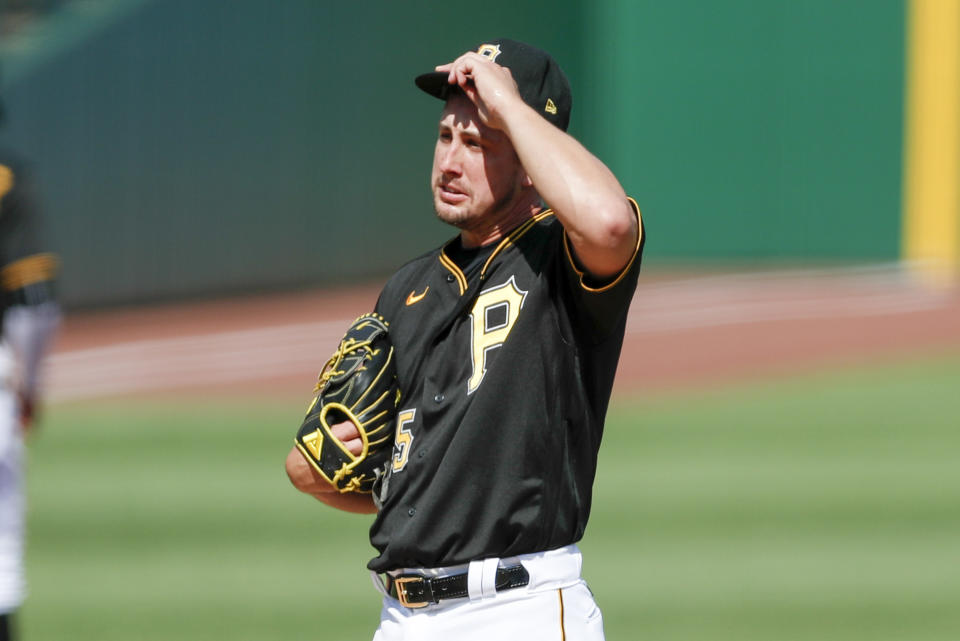 Pittsburgh Pirates relief pitcher Derek Holland adjust his cap after giving a home run to Detroit Tigers' Jeimer Candelario in the first inning of a baseball game against the Pittsburgh Pirates, Saturday, Aug. 8, 2020, in Pittsburgh. (AP Photo/Keith Srakocic)