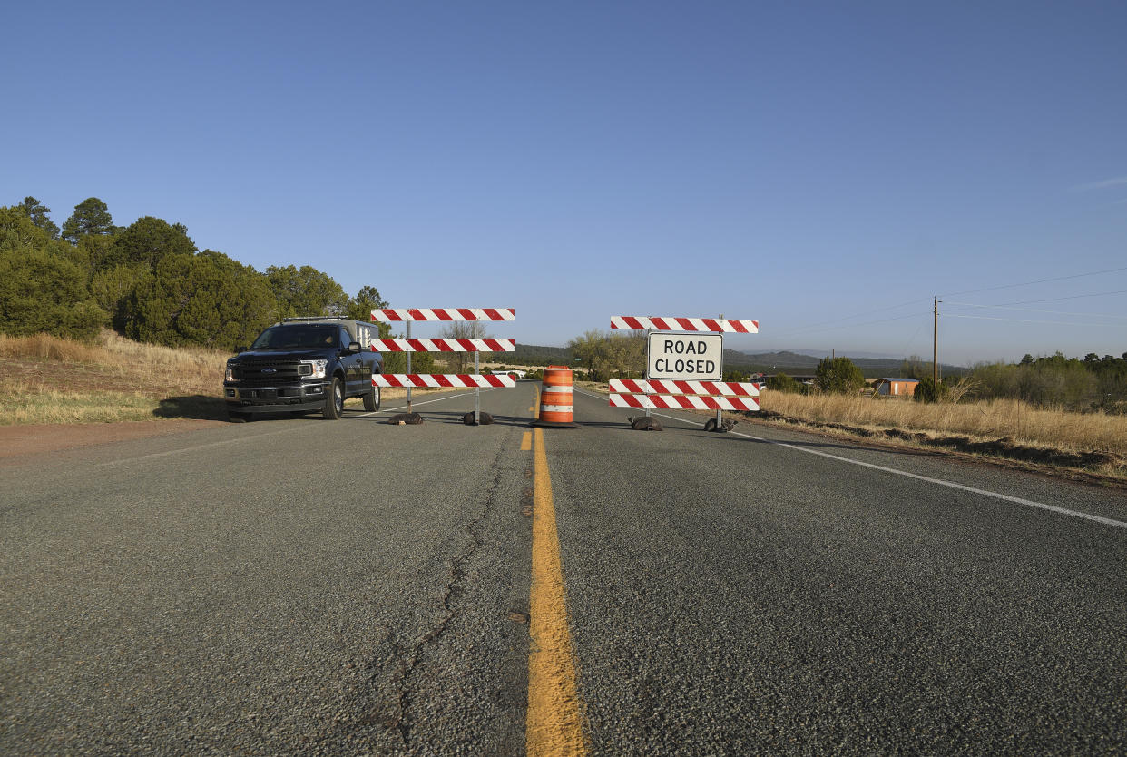 Road blocks are erected in Las Vegas, N.M., on Tuesday, May 3, 2022. (AP Photo/Thomas Peipert)