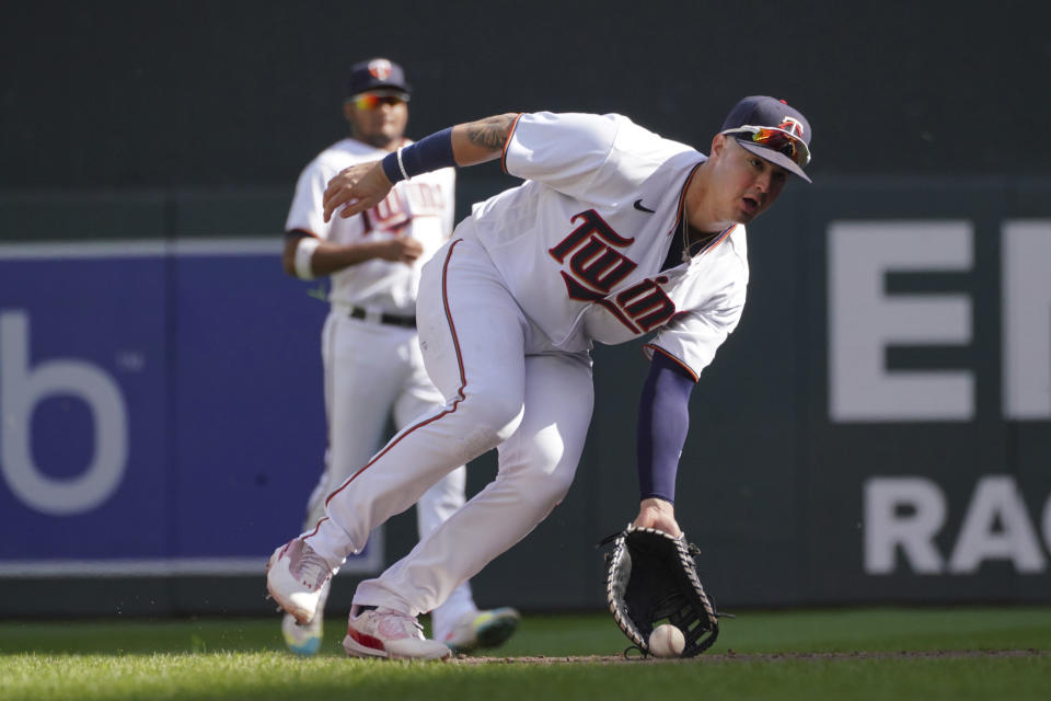 Minnesota Twins first baseman Jose Miranda scoops a grounder off the bat of Los Angeles Angels' Matt Thaiss for an out in the fifth inning of a baseball game, Sunday, Sept 25, 2022, in Minneapolis. (AP Photo/Jim Mone)