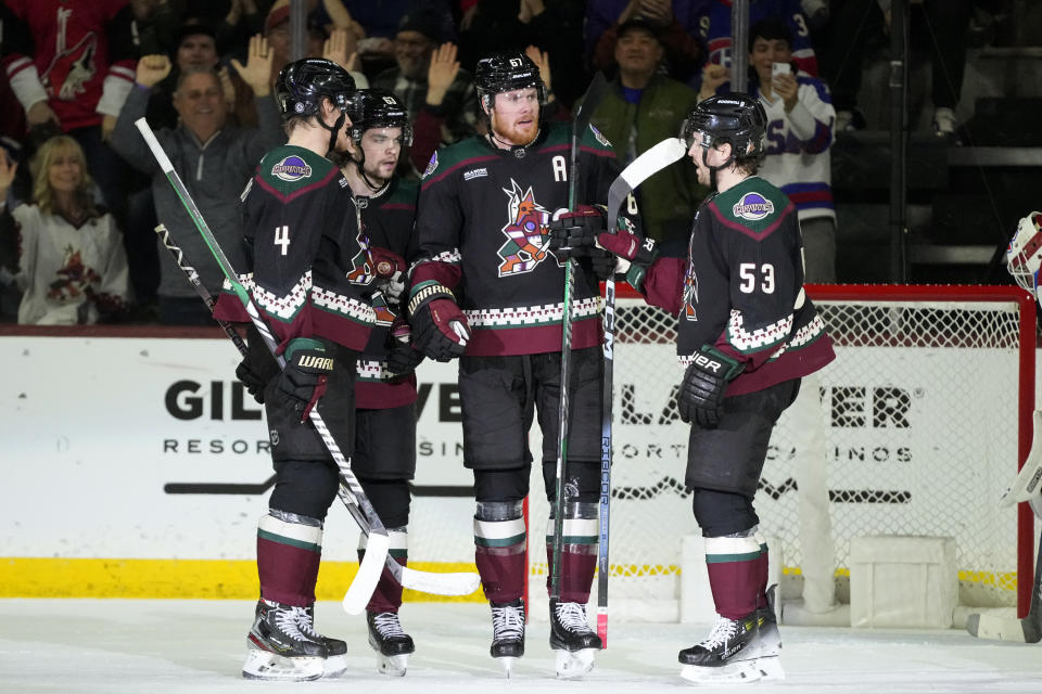 Arizona Coyotes left wing Lawson Crouse (67) celebrates after his goal against the Montreal Canadiens with defenseman Juuso Valimaki (4), left wing Matias Maccelli (63) and left wing Michael Carcone (53) during the second period of an NHL hockey game Thursday, Nov. 2, 2023, in Tempe, Ariz. (AP Photo/Ross D. Franklin)