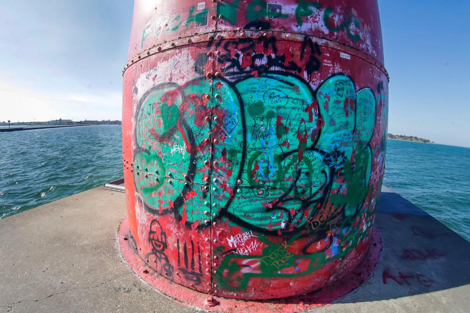 In this fisheye lens view, extensive elaborate graffiti is seen on the eastern side of the Sheboygan lighthouse, Tuesday, October 3, 2023, in Sheboygan, Wis.