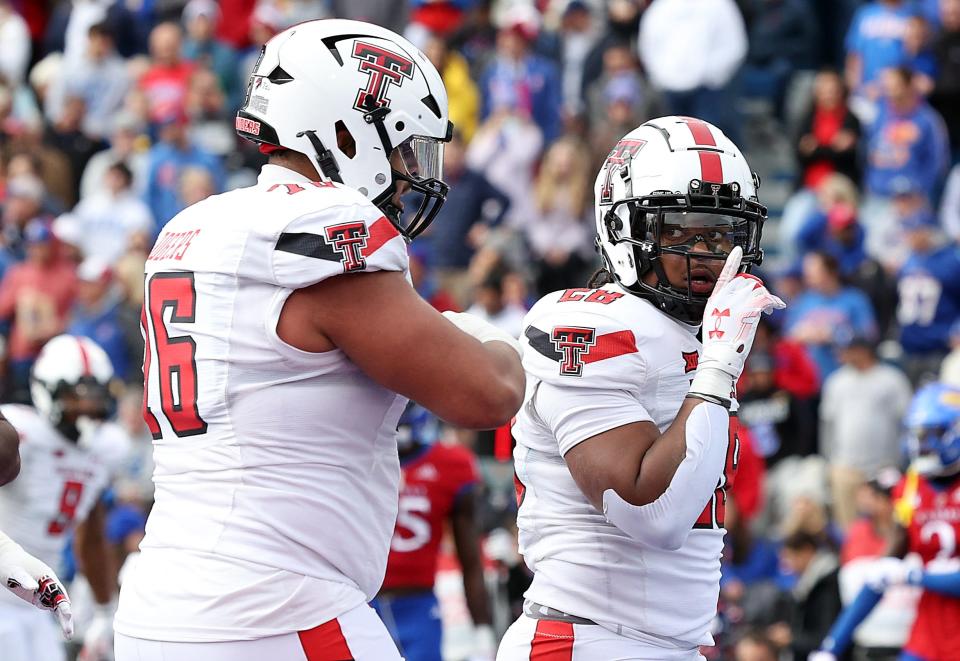 Texas Tech tackle Caleb Rogers, left, and running back Tahj Brooks, right, celebrate a Brooks touchdown during the Red Raiders' 16-13 victory Saturday at Kansas. Tech's last home game is Saturday against Central Florida, and Rogers and Brooks both are scheduled to go through the Red Raiders' senior day ceremony, though both have the option to return in 2024 on the Covid-bonus year.