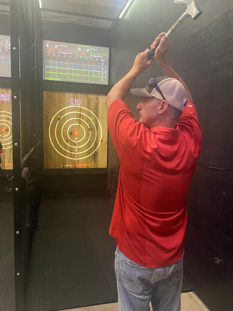 Y101 DJ Dan Mahoney demonstrates axe-throwing technique as part of an "Axes & Ales" event at Ryan's in South Yarmouth.