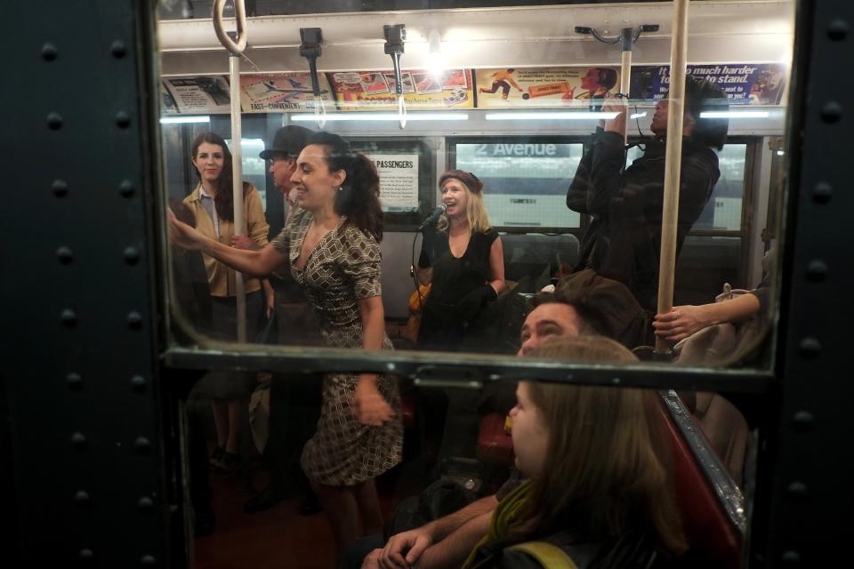 NEW YORK, NY - DECEMBER 16: People dance to live music in a vintage New York City subway car as it sits in the 2nd Ave. station on December 16, 2012 in New York City. The New York Metropolitan Transportation Authority (MTA) runs vintage subway trains from the 1930's-1970's each Sunday along the M train route from Manhattan to Queens through the first of the year. (Photo by Preston Rescigno/Getty Images)