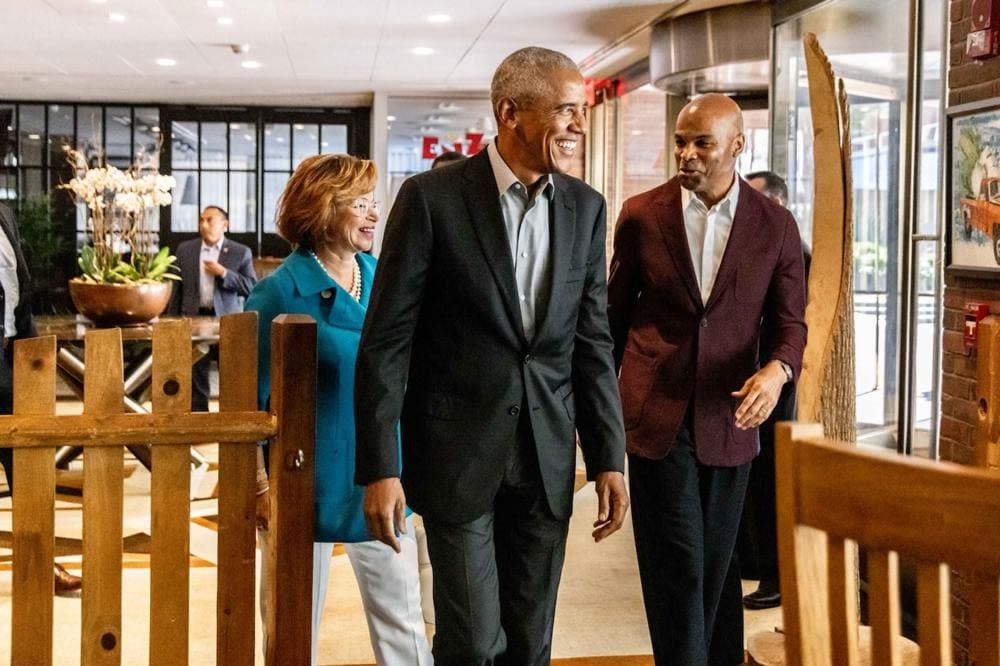 In this photo provided by Dylan Goodman, former President Barack Obama, center, walks with Valerie Jarrett, left, and Harvard basketball coach Tommy Amaker on their way into “The Breakfast Club” in Cambridge, Mass., Friday, Sept. 9, 2022. (Dylan Goodman via AP)