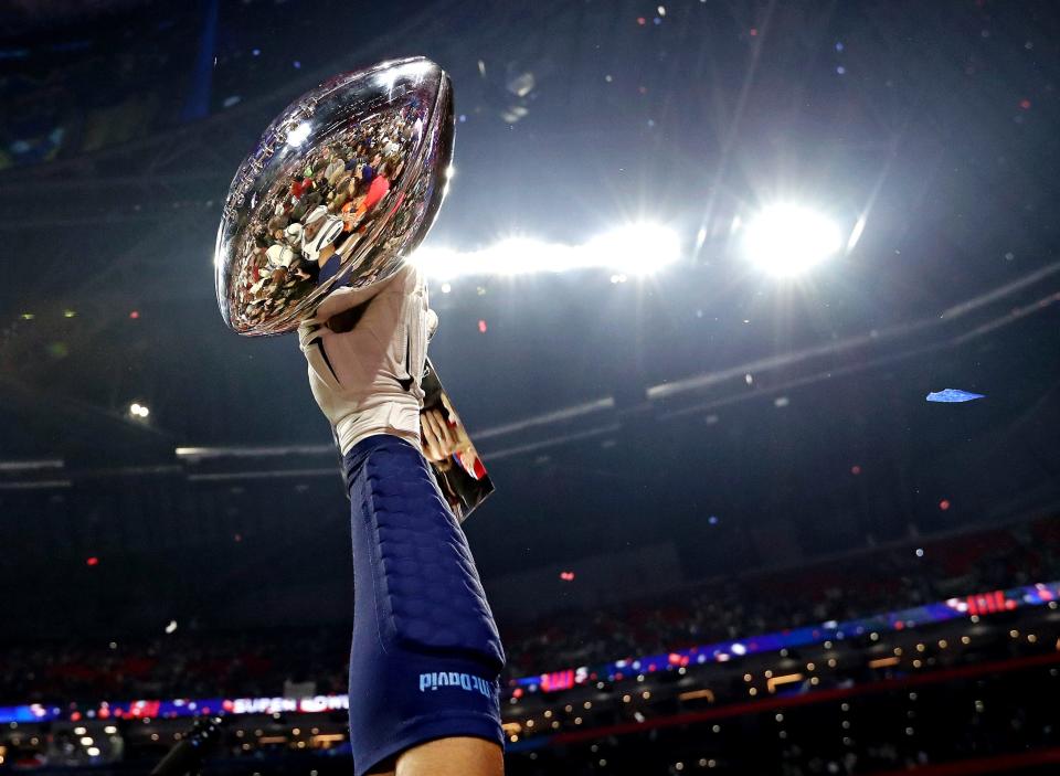 The New England Patriots celebrates with the Vince Lombardi Trophy after beating the Los Angeles Rams in Super Bowl LIII at Mercedes-Benz Stadium.