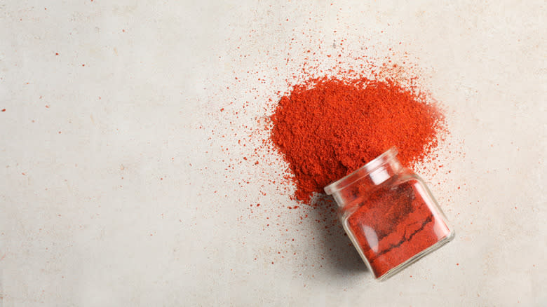 Cayenne pepper spilling from jar