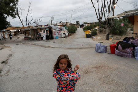 Dayana Stan, 6, feels cold as she waits to move out of El Gallinero shanty town and into a new apartment in Madrid, Spain, September 26, 2018. REUTERS/Susana Vera