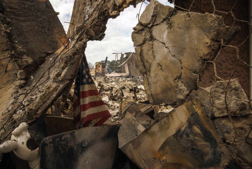 The remains of a structure destroyed by the Apache Fire as it burns in Palermo, Calif., on Tuesday, Jun. 25, 2024. According to Cal Fire, more than a dozen new fires sparked by lightning. (AP Photo/Ethan Swope)