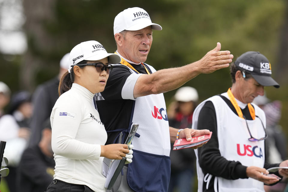Nasa Hataoka, of Japan, plans her shot with her caddie on the ninth tee during the first round of the U.S. Women's Open golf tournament at the Pebble Beach Golf Links, Thursday, July 6, 2023, in Pebble Beach, Calif. (AP Photo/Darron Cummings)