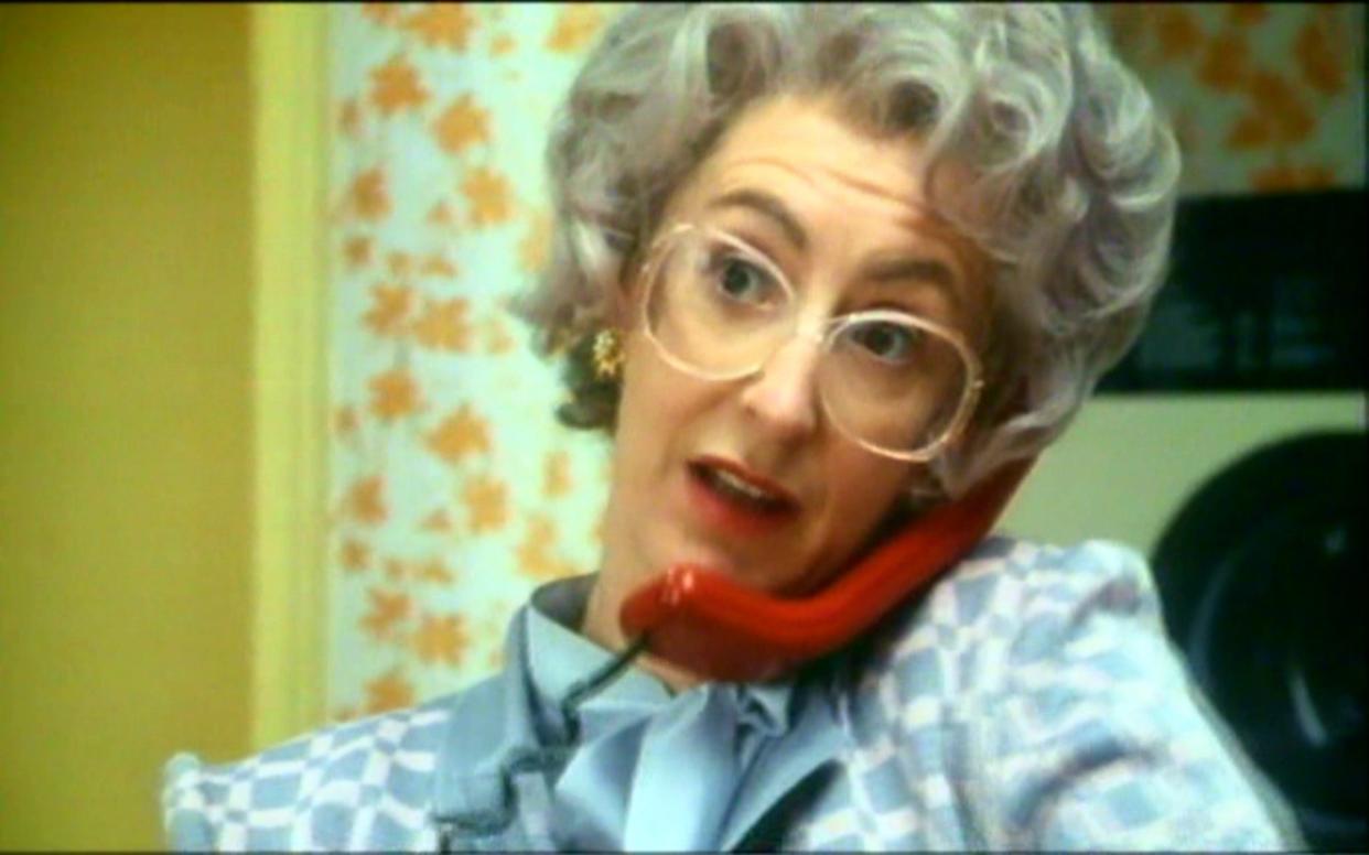 Woman on the landline phone leaving a voicemail - Advertising Archives