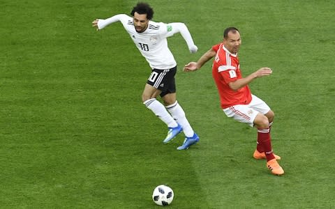 Egypt's forward Mohamed Salah dribbles past Russia's defender Sergey Ignashevich - Credit: AFP