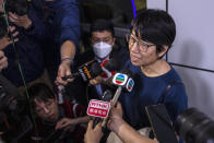 Elizabeth Tang, the former chief executive of the now-disbanded pro-democracy group Hong Kong Confederation of Trade Unions, speaks to the press as she walks out the police station in Hong Kong, on Saturday, March 11, 2023. Tang, who was arrested for endangering national security earlier this week, was released on bail on Saturday.(AP Photo/Louise Delmotte)