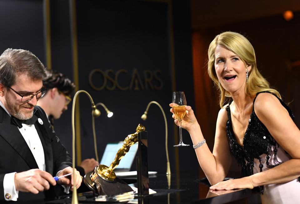 Laura Dern looks appropriately enthused by her very first Academy Award being engraved at the 92nd Oscars Governors Ball. 