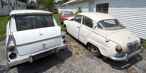 Jeffrey Huntsman’s 1967 Saab 95 and Saab 96 cars sit in front of a 1966 Jaguar 3.8S in Harrodsburg. David Snodgress | Herald-Times