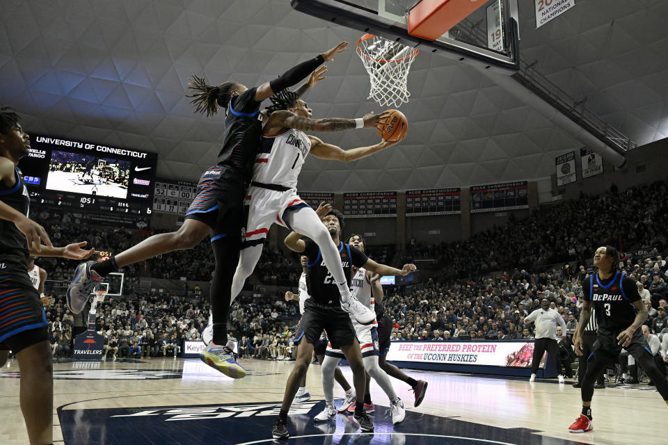 UConn guard Solomon Ball shoots as DePaul forward Da'Sean Nelson, top left, defends in the first half of an NCAA college basketball game, Tuesday, Jan. 2, 2024, in Storrs, Conn. (AP Photo/Jessica Hill)