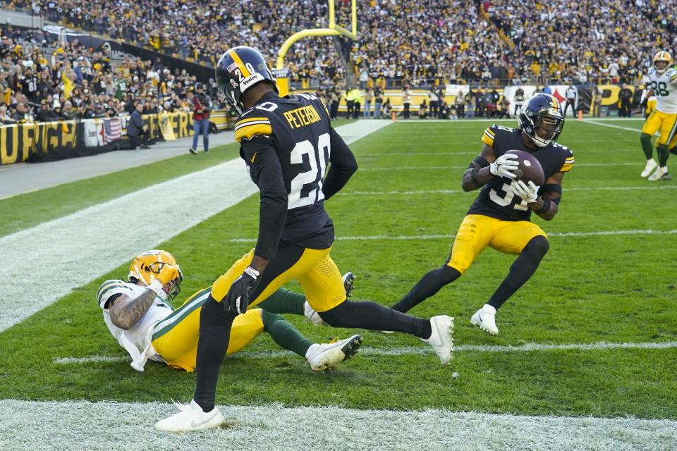 Pittsburgh Steelers' Keanu Neal intercepts a pass intended for Green Bay Packers' Christian Watson during the second half of an NFL football game Sunday, Nov. 12, 2023, in Pittsburgh. (AP Photo/Matt Freed)